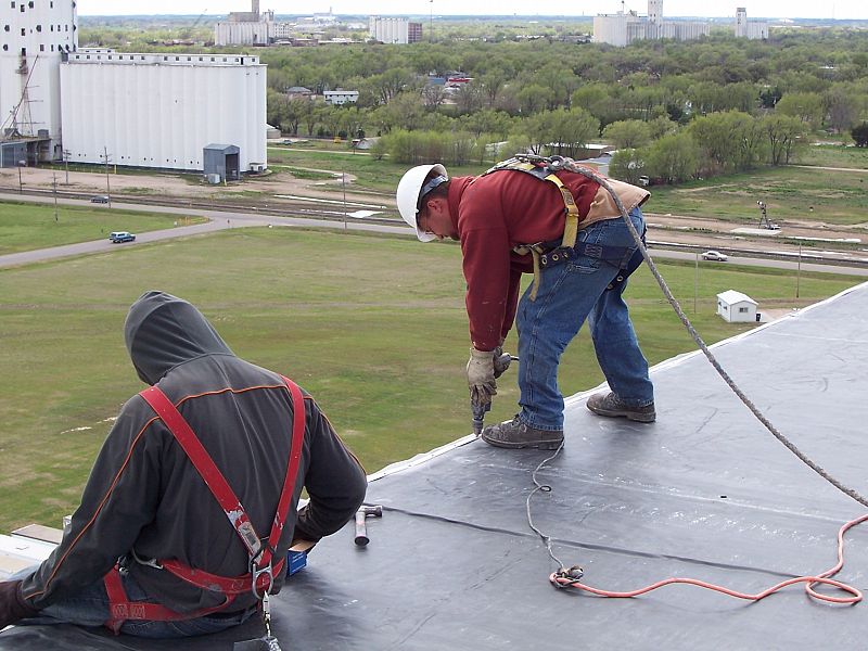 Employees working on a flat top roof