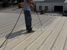 Power washing a flat top roof